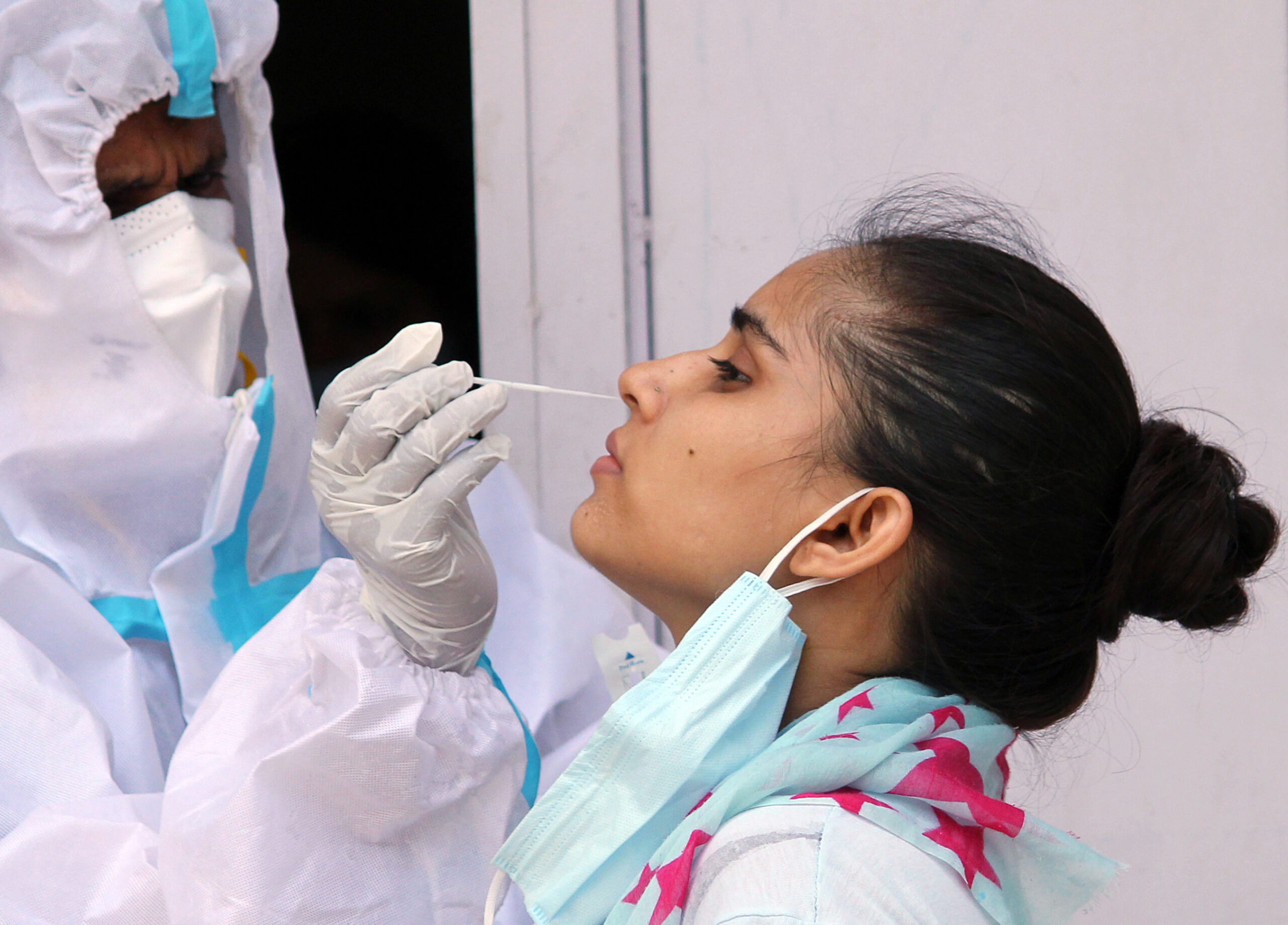 A health worker collects a nasal sample for Covid-19 Ag rapid antigen testing at Chakkarpur Community Centre
